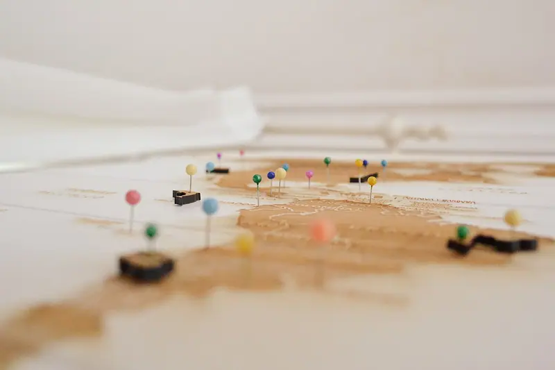Coloured pins marking places on a world map