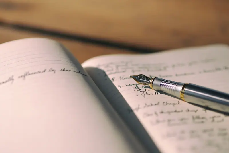 A fountain pen writing in a journal